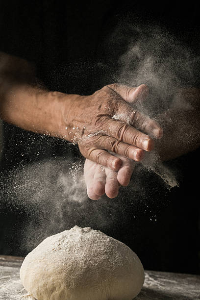 istock Elderly Hands Kneading Dough for Homemade Bread 2226400073