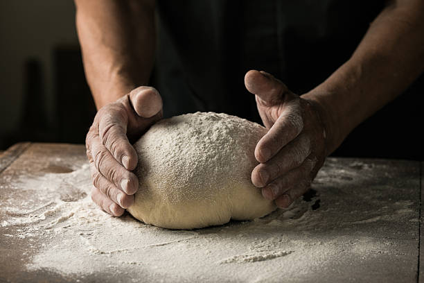 istock Elderly Hands Kneading Dough for Homemade Bread 2226400074