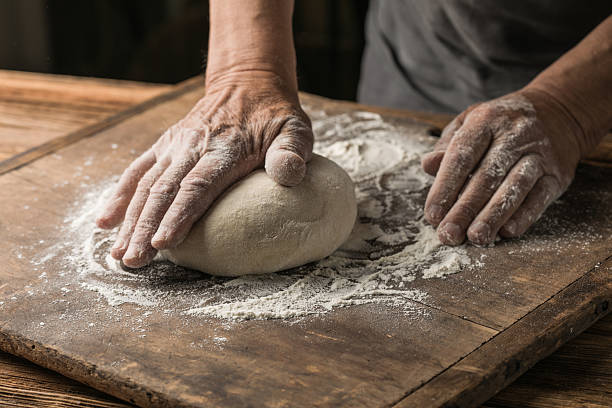 istock Elderly Hands Kneading Dough for Homemade Bread 2226400077
