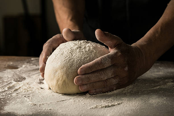 istock Elderly Hands Kneading Dough for Homemade Bread 2226400079
