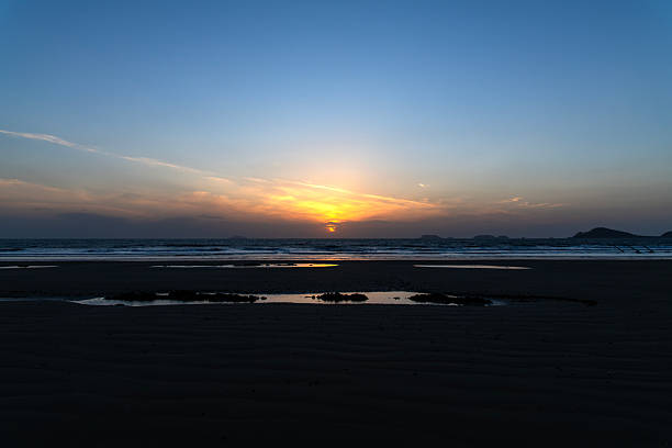istock beach and sunset over the sea in winter 2226400424