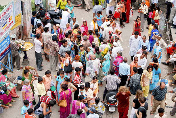 Rishikesh, India, June 21, 2024: A lively street scene in Rishikesh, India, depicting a dense crowd of pilgrims, locals, and tourists during a spiritual gathering