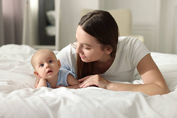 istock Mother with her cute baby on bed indoors 2226403379