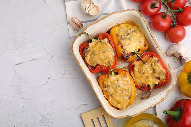istock Delicious stuffed peppers in baking dish, spatula and ingredients on white textured table, flat lay. Space for text 2226404137