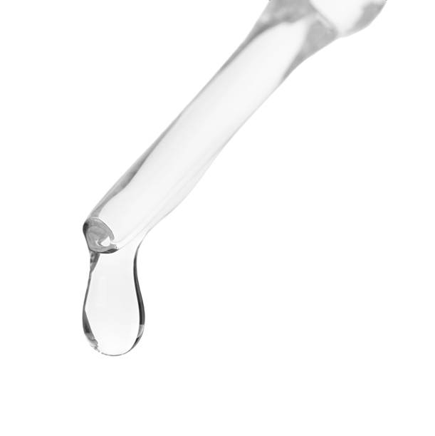 istock Dripping liquid from pipette isolated on white, closeup 2226404716