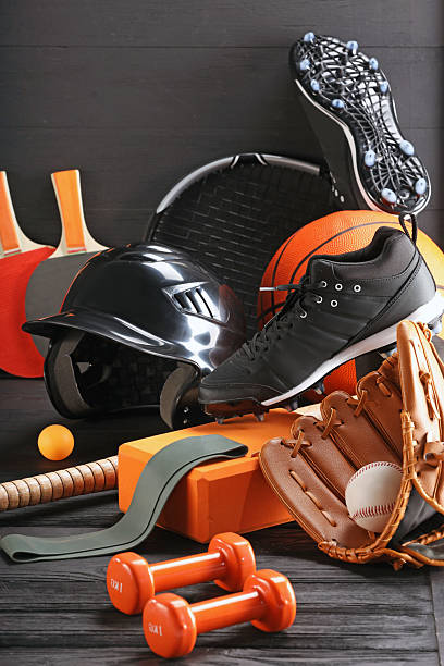 istock Many different sports equipment on dark grey wooden table 2226405236