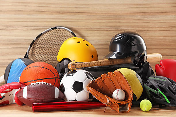 istock Many different sports equipment on wooden table 2226405271