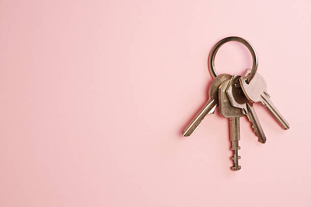 istock top view bunch of key against pink background. 2226407638