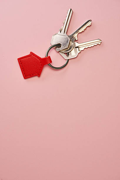 istock red house shape key ring against pink background 2226407649