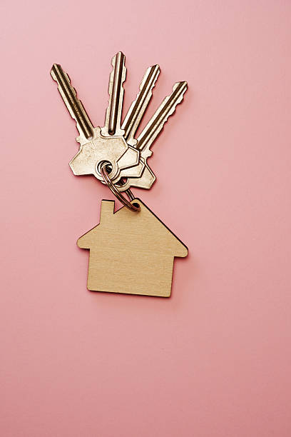 Keychain with key ring isolated on a colored background. Concepts for real estate and moving home or renting property. Buying a property. Mock-up keychain.Copy space.