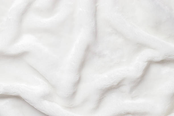 istock White Faux Fur Texture, Soft, white artificial fur with fluffy texture and gentle shadows. Close-up textile background delicate textures, top view, copyspace, backdrop with soft folds 2226407809