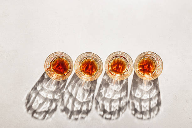 istock Crystal Whiskey Glasses with shadows at sunlight on beige concrete background, minimal aesthetic top view shiny glasses, sun glare, stong alcohol drink concept, summer still life top view, copy space 2226407852