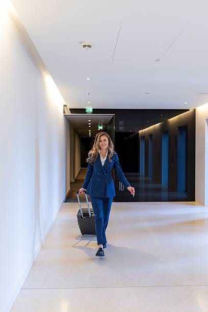 istock A confident business professional walks gracefully through a modern office corridor 2226408395