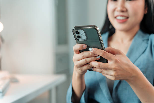 istock Young Asian businesswoman using mobile phone in office 2226409348