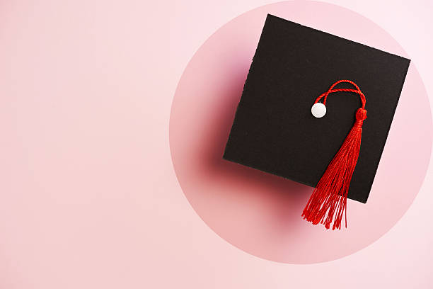 istock Top view of small mortarboard against pink background 2226410267