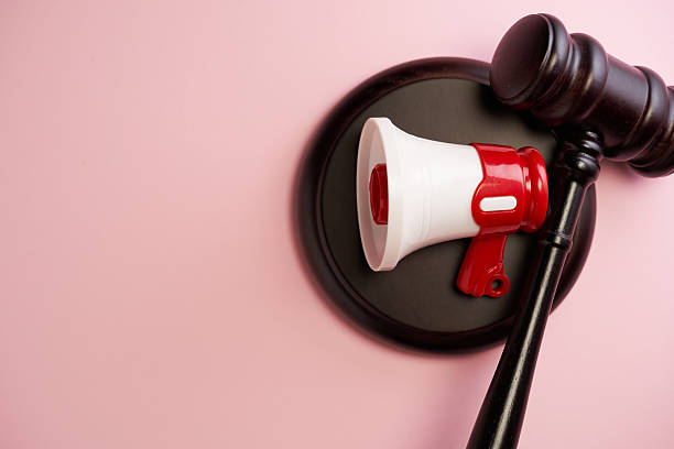 istock gavel hammer and small megaphone  on the pink background top view 2226410273