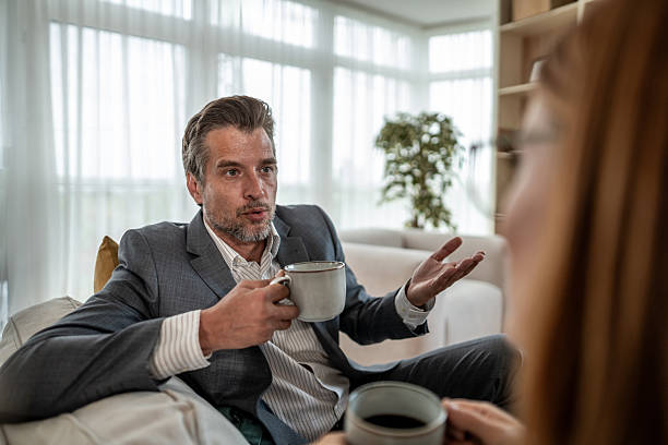 istock Businessman talking and drinking coffee with a colleague in office 2226410664
