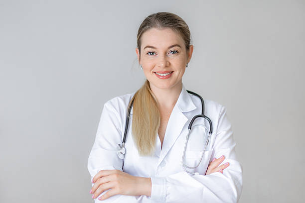 istock Smiling female doctor standing with confidence in a white lab coat 2226412390