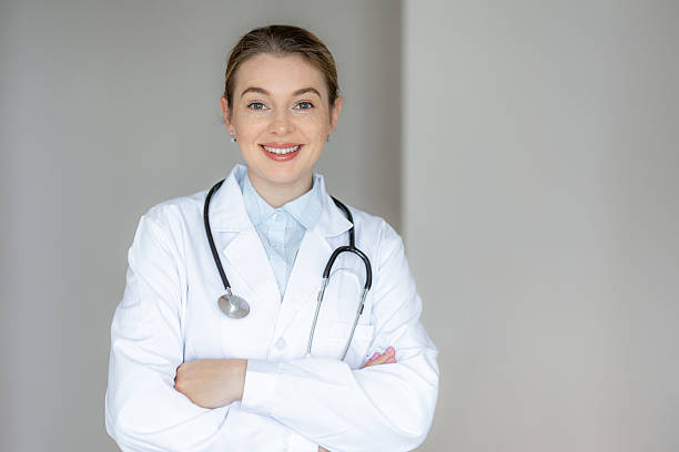 istock Smiling female doctor in a white coat with a stethoscope 2226412417