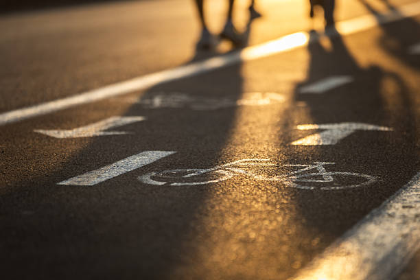 Bike way sing on the floor, public park view at sunset.