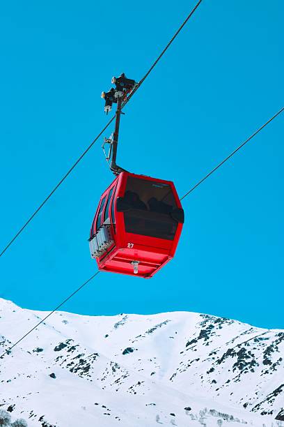 Modern gondola lift connecting Kobi and Gudauri in Caucasus mountains Georgia, scenic ski resort transport with snowy peaks, popular winter tourism, skiing and snowboarding travel destination.