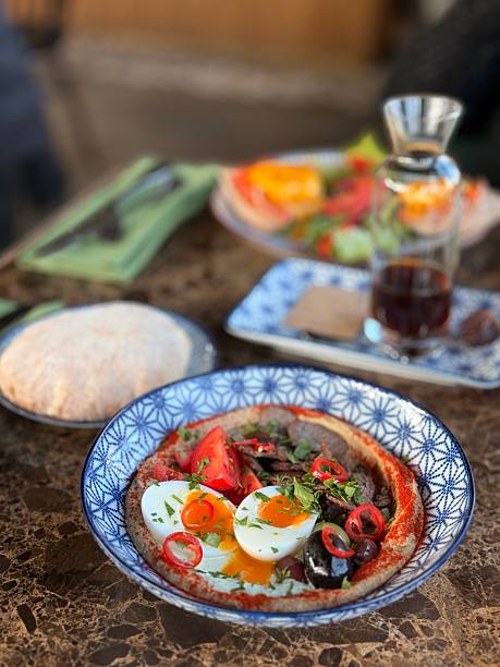 istock Gourmet Middle Eastern breakfast with hummus, eggs, and fresh vegetables 2226415307