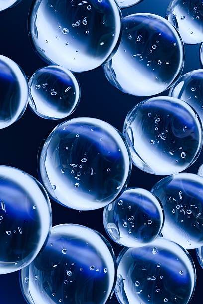 istock Transparent blue bubbles floating in a dark liquid, with reflections and small air particles inside. Abstract 3D rendering representing purity, science, or molecular structure. 2226415626