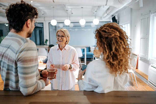 istock Colleagues casually talking during coffee break at the office 2226417026