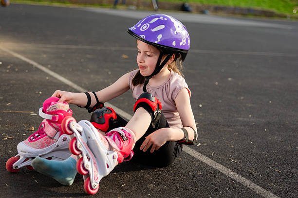istock Girl sits on the floor and puts on roller skates. 2226417646