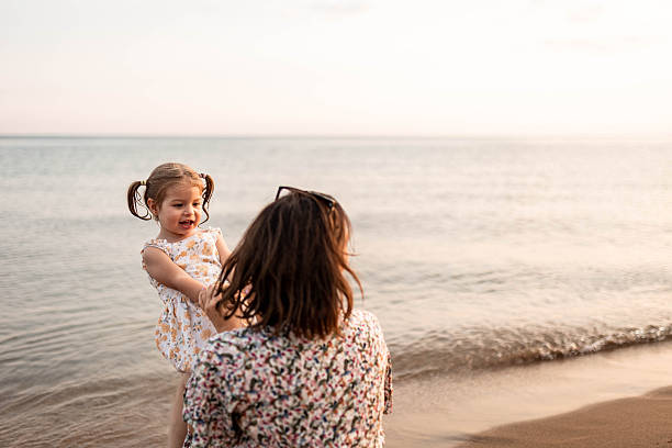istock Mother Relaxing as Her Daughter Plays on Her Lap 2226418655