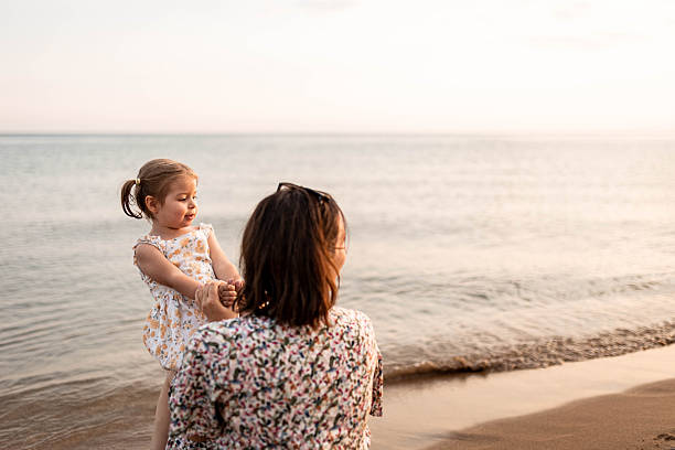 istock Mother Relaxing as Her Daughter Plays on Her Lap 2226418668