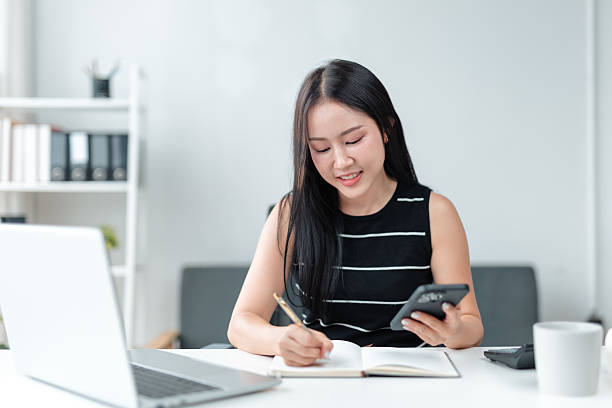 istock Asian businesswoman working and taking notes in her office 2226418737