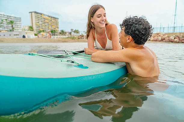 istock Young couple relaxing on paddle board in ocean 2226419050