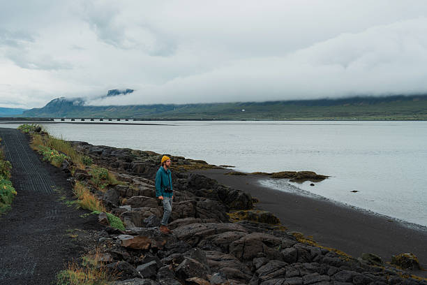 Serene man walking along the seaside in Iceland