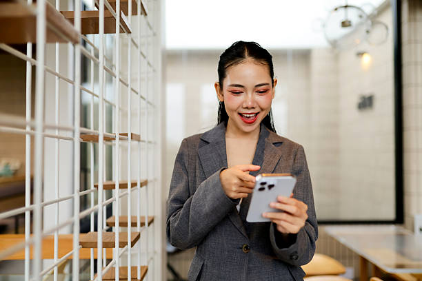 istock Young businesswoman using mobile phone in modern office 2226421754