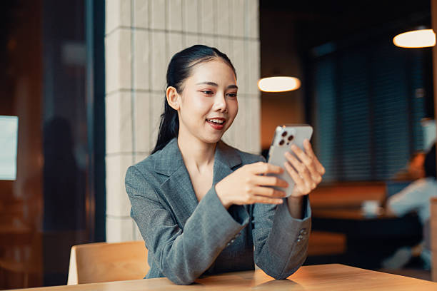 istock Young Asian businesswoman using smartphone in a cafe 2226421838