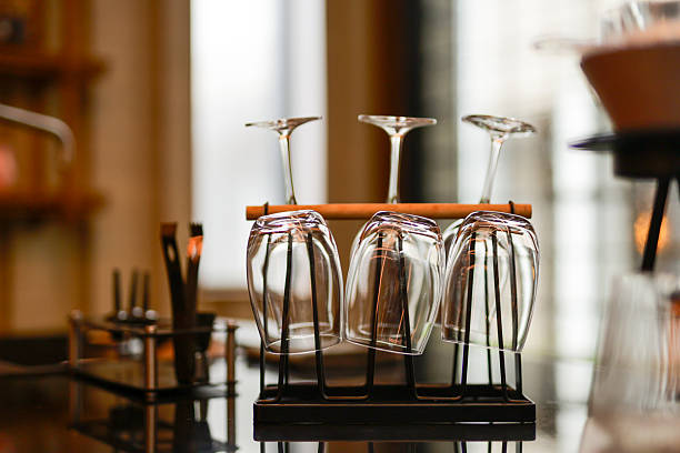 Wine glasses hanging upside down to dry in a bar