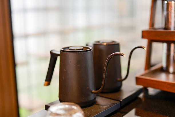 istock Two elegant black gooseneck kettles resting on a kitchen counter 2226421920