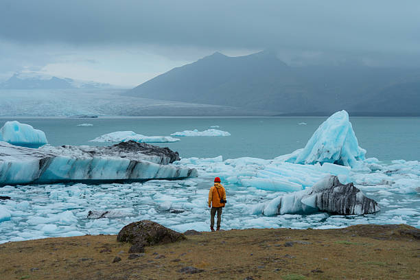 istock Man walking near glacier lagoon in Iceland 2226422201