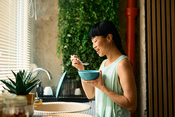istock Woman enjoying a healthy breakfast in her modern kitchen 2226423284
