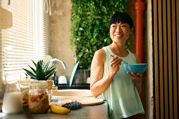 istock Smiling woman enjoying a healthy breakfast in her modern kitchen 2226423300