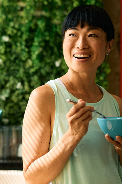 istock Smiling woman enjoying a healthy breakfast in her modern kitchen 2226423303