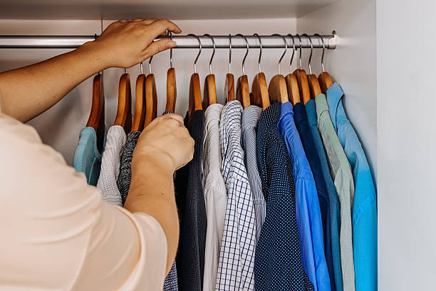 istock Woman sorting shirts in stylish minimalist wardrobe. 2226424360