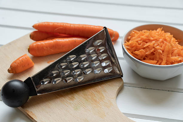 Fresh organic shredded carrots on cutting board