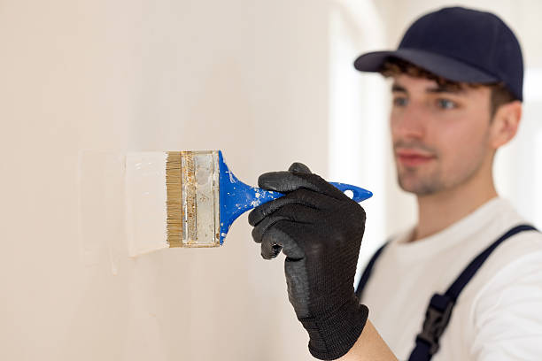 istock Man painting wall near window 2226428721