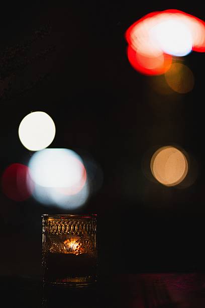A vintage cup with night city lights in the background