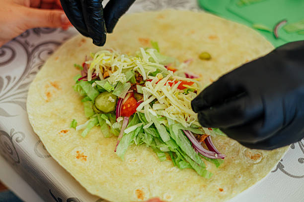 istock Assembling a Fresh Tortilla Wrap with Vegetables and Cheese 2226432261