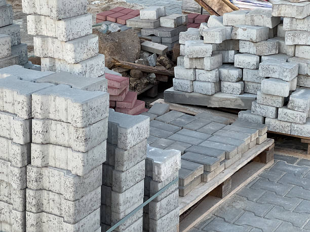 istock Stacks of concrete and brick blocks arranged neatly at a construction site in bright daylight, showcasing building materials for projects 2226432523