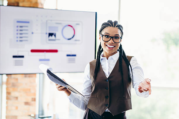 istock Young businesswoman presenting analytics in modern office setting with charts and reports for a professional audience 2226433560
