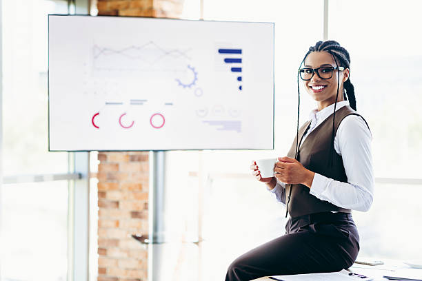 istock Confident businesswoman presenting analytics report in modern office environment, showcasing career success and professionalism 2226433604